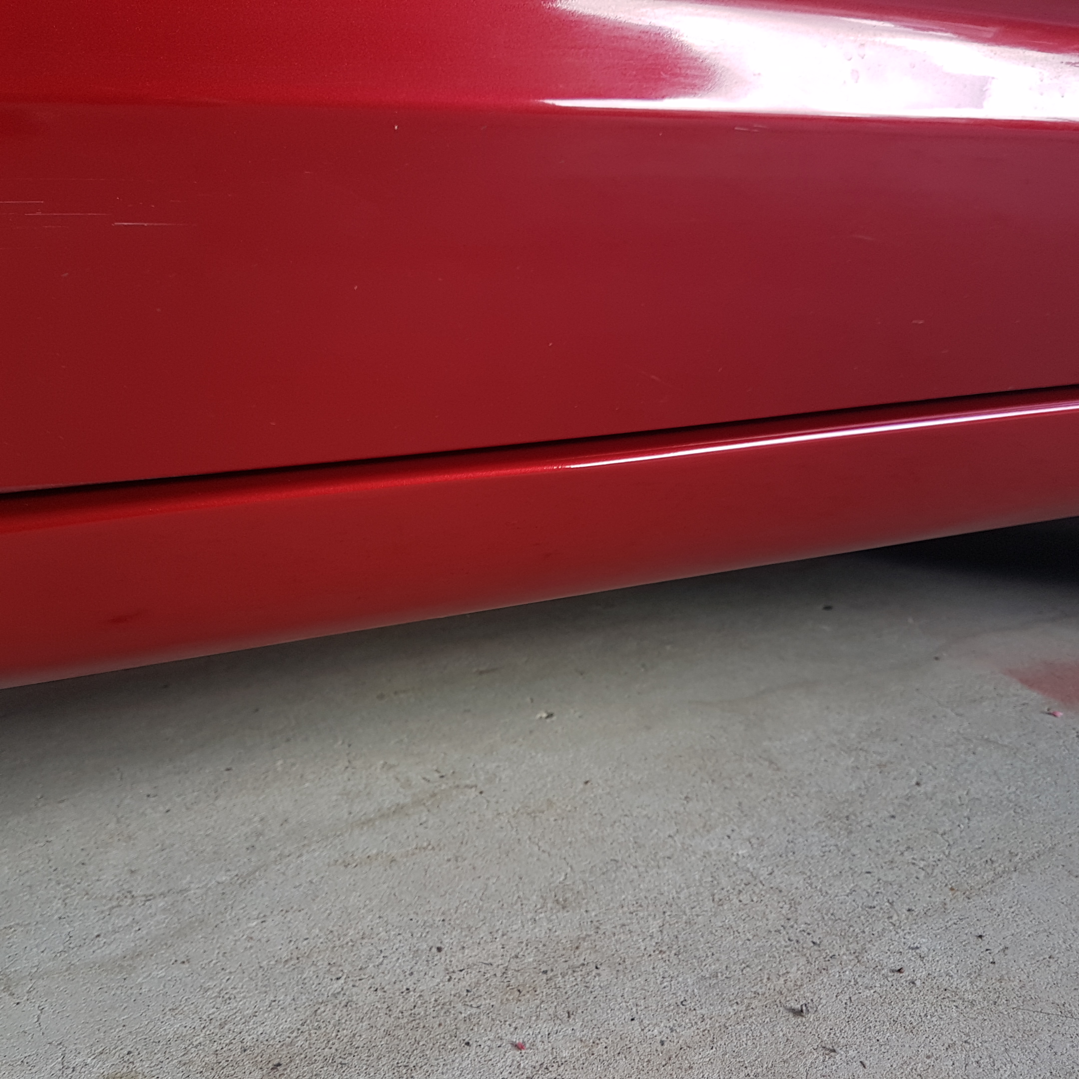 After photo of repaired red lower door and side skirt paintwork