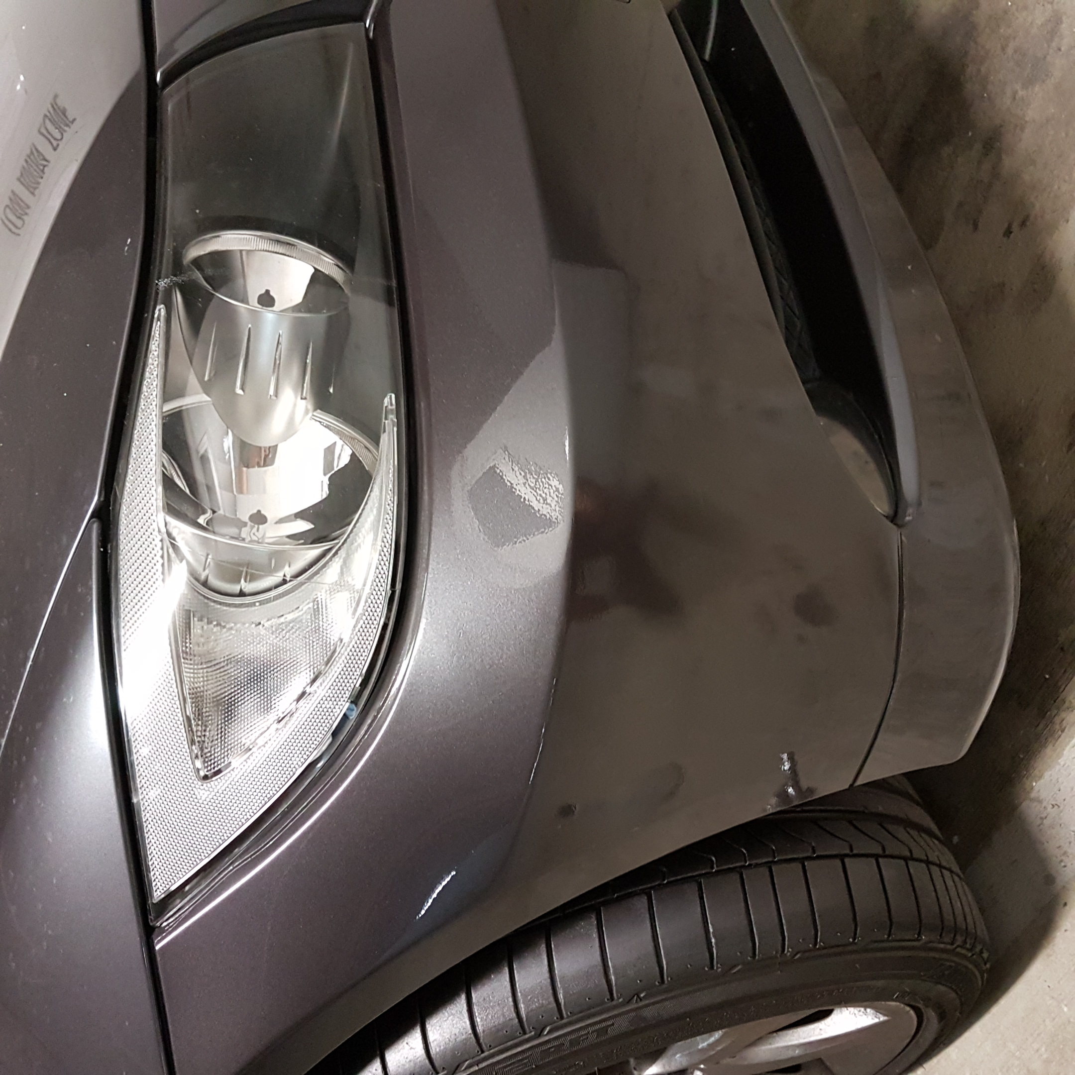 After photo of a repaired grey bumper and front guard corner